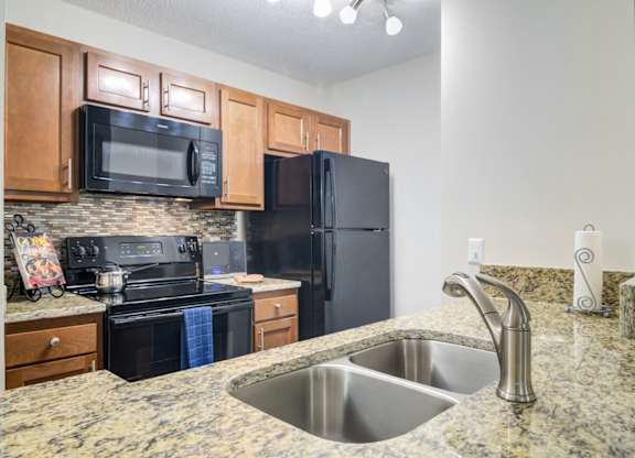 West Marietta, GA Apartments – Wood Pointe Apartments – A kitchen with black appliances