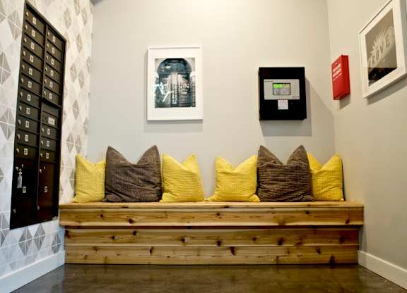 A room with a bench and a painting on the wall.