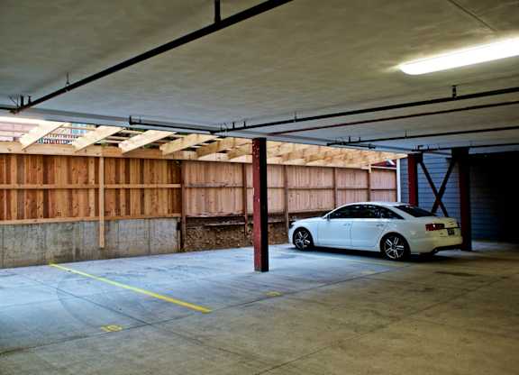 A white car is parked in a garage.