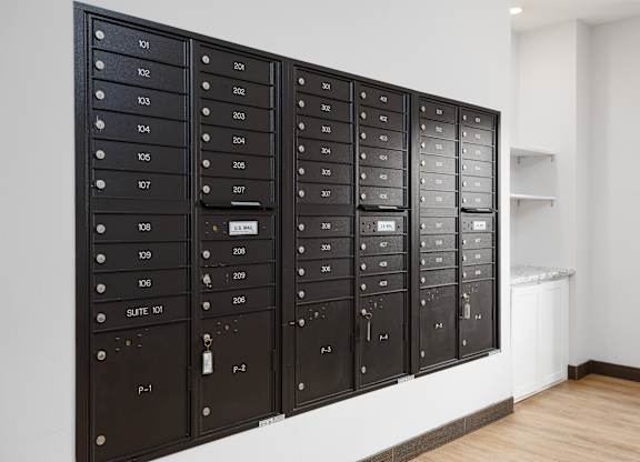 A wall of mailboxes with the numbers 101 to 123 on them.