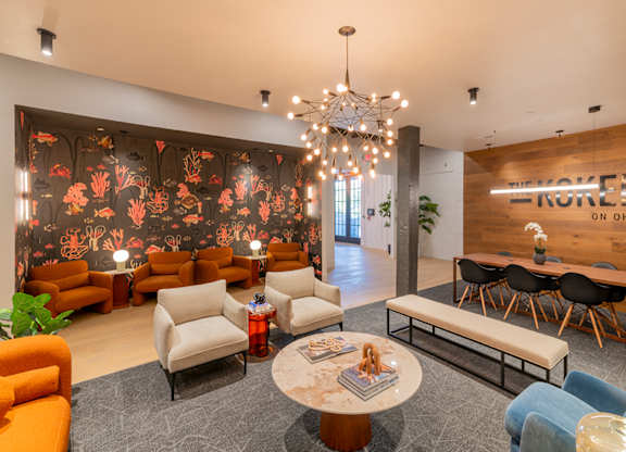 A room with a wooden table and chairs and a sign that says