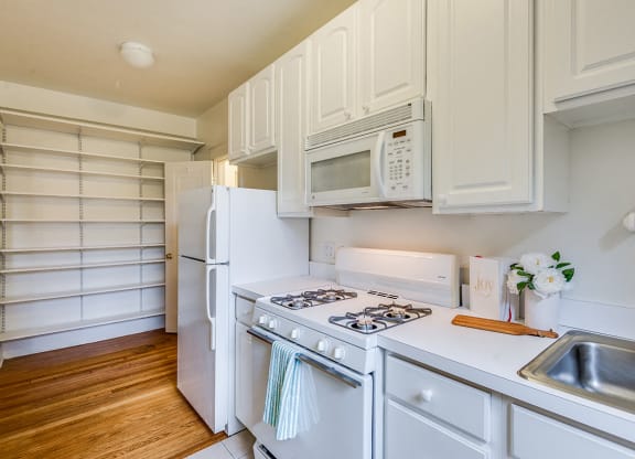 Apartment kitchen with classic finishes and pantry space at 4115 Wisconsin, Washington, DC, 20016