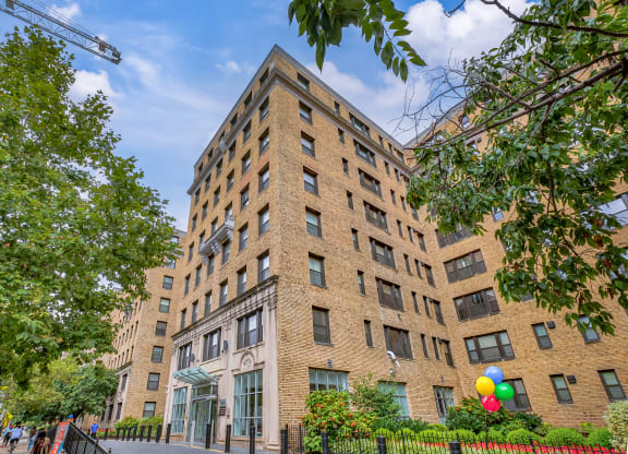 a tall brick building with balloons in front of it at The Argonne Apartments, Washington, DC, 20009