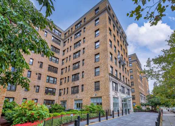 a large brick building with a sidewalk in front of it at The Argonne Apartments, Washington