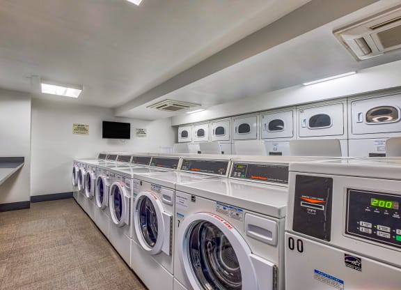 a washer and dryer closet in a laundry room with lots of washing machines at The Argonne Apartments, Washington, 20009