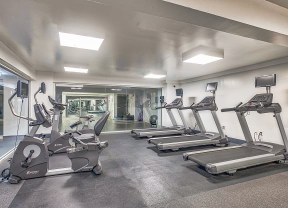 a gym with treadmills and other exercise equipment at The Argonne Apartments, Washington, Washington DC