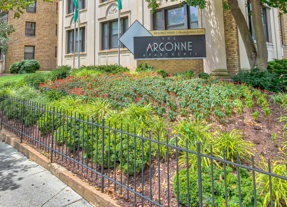 an apartment building with a sign in front of a garden at The Argonne Apartments, Washington DC