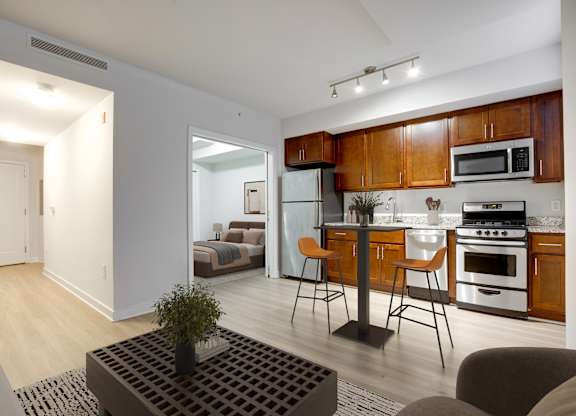 A modern kitchen with wooden cabinets and stainless steel appliances.