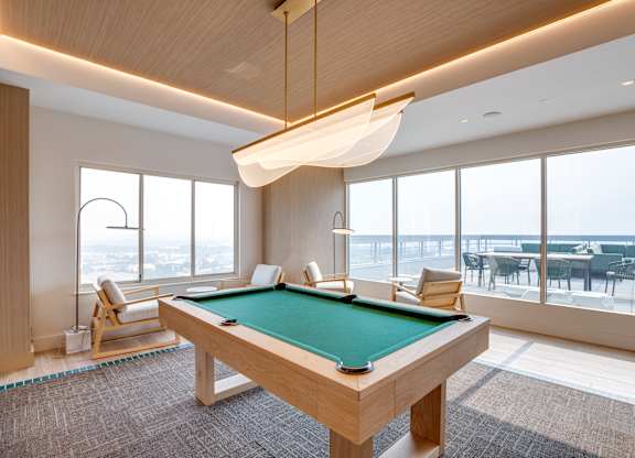 Newly renovated rooftop resident lounge with pool table at Lenox Club Apartments in National Landing, VA 22202