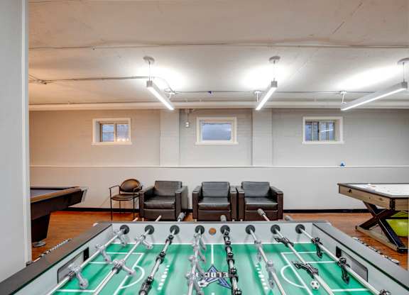 Game room with a foosball table at Mason Hall in Alexandria, VA 22314