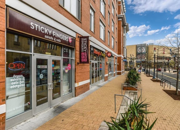 a city street with a brick sidewalk in front of a store at The Argonne Apartments, Washington, 20009