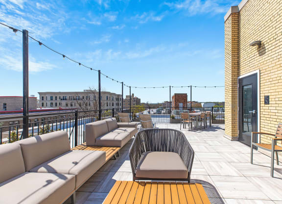 a rooftop deck with couches and tables on a sunny day  at Connecticut Gardens, Washington, DC