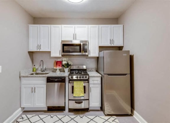 Studio apartment kitchen with stainless steel appliances at The York and Potomac Park, Washington, Washington