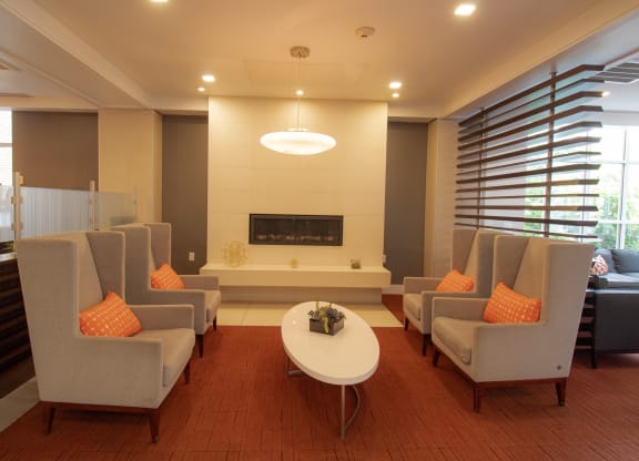 room with couches and a table and a fireplace at The Argonne Apartments, Washington, DC, 20009