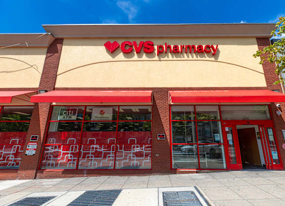 A CVS Pharmacy store with a red awning and glass doors.