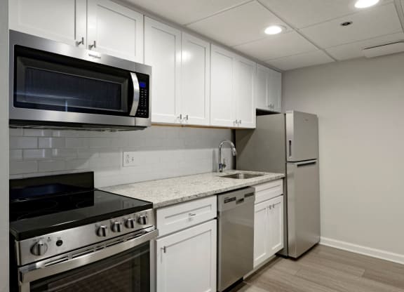 Renovated kitchen with granite countertops and stainless steel appliances  at Lenox Club, National Landing, Arlington, VA 22202