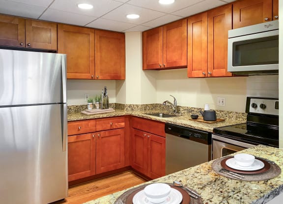 Kitchen with granite countertops and stainless steel appliances  at Lenox Club, National Landing, Arlington, VA 22202
