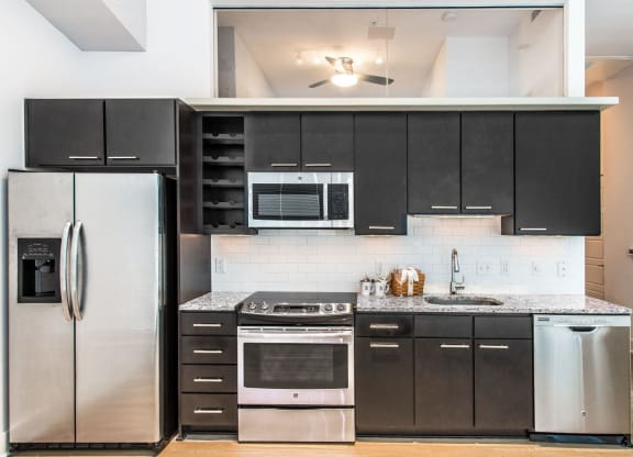 Kitchen with granite countertops and stainless steel appliances at Lex and Leo at Waterfront Station, Washington, DC 20009