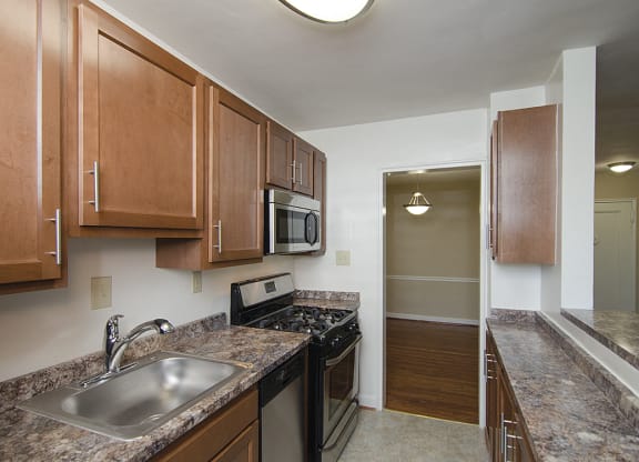 Partially renovated kitchen with stainless steel appliances at Mason Hall in Alexandria, VA 22314