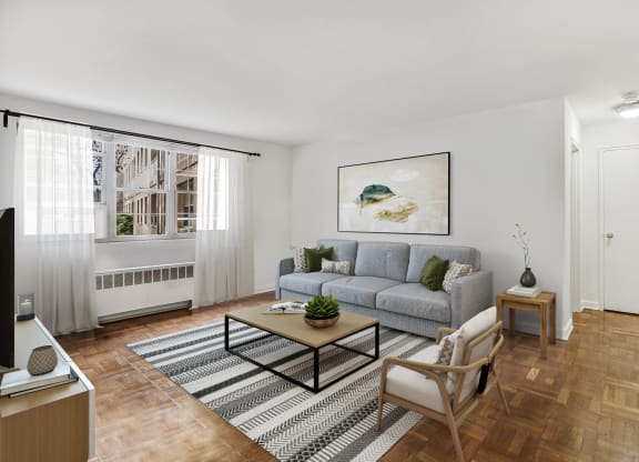 Living room with a gray couch and a coffee table at Mason Hall in Alexandria, VA 22314