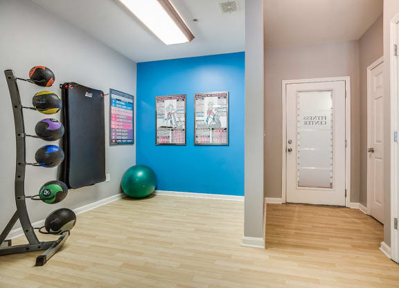a home gym with a blue wall and a treadmill at The Residences at King Farm, Rockville, 20850
