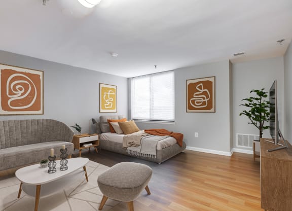 a living room with a couch and a bed at Residences at Rio, Maryland