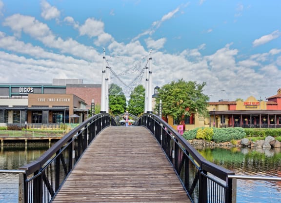 a bridge over a body of water with buildings on either side at Residences at Rio, Maryland