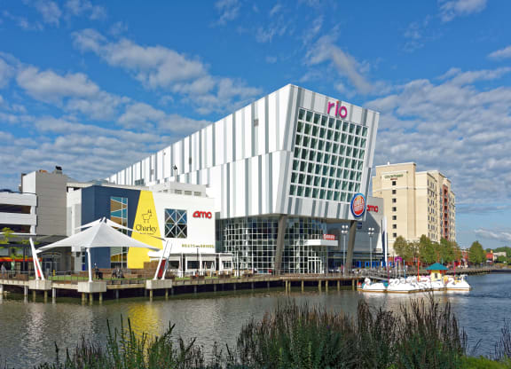 a large white building next to a body of water at Residences at Rio, Gaithersburg, MD