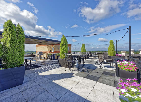 an outdoor patio with tables and chairs and awning