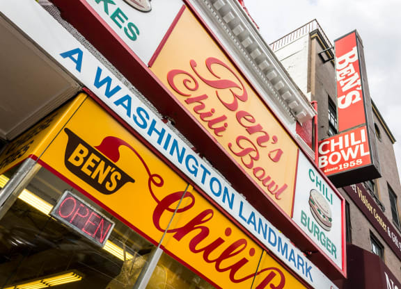 a row of neon signs on the side of a building at The Shay, District of Columbia 20001