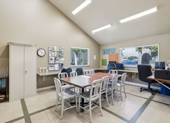 a dining room with a table and chairs and a desk