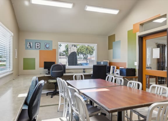 a conference room with a table and chairs and a window