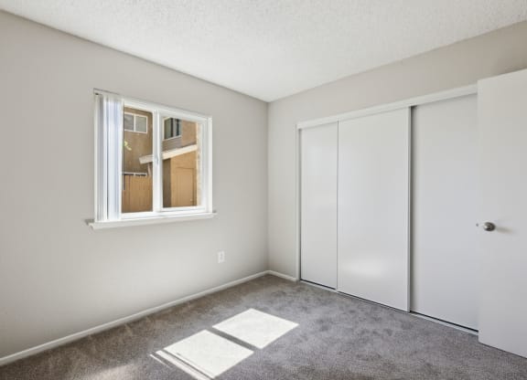 an empty room with white walls and a window