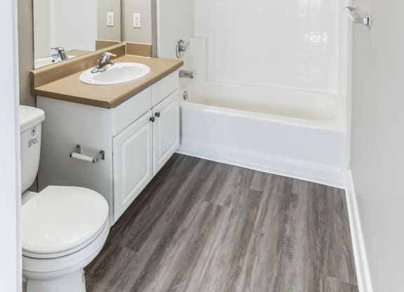 an empty bathroom with a sink toilet and shower