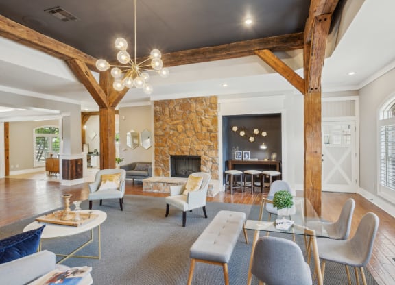 a living room with a stone fireplace and furniture