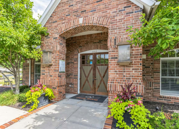 the entrance to a brick building with a wooden door