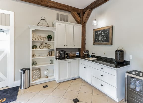 a kitchen with white cabinets and a counter top and a sink