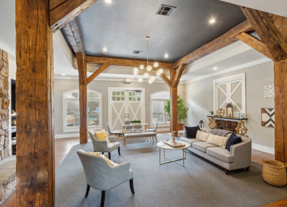 a living room with wooden beams and furniture and a fireplace