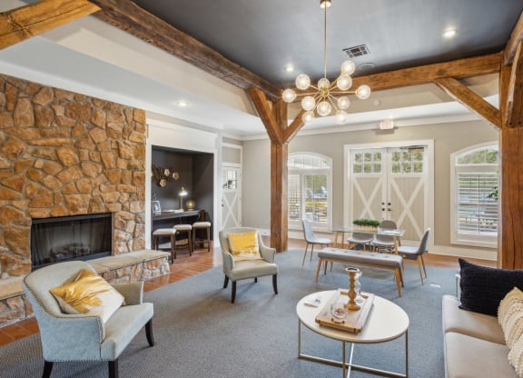 a living room with couches and chairs and a fireplace
