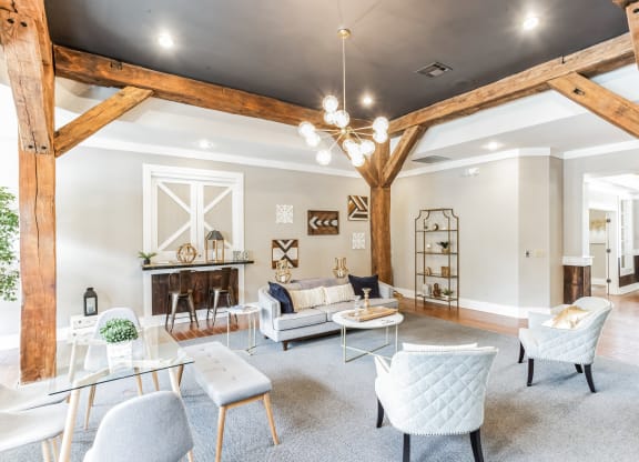 a living room with a vaulted ceiling and exposed wooden beams