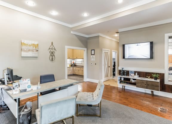 a home office with a desk and a tv