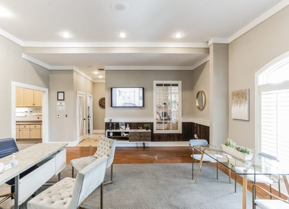 a living room with a dining room and a kitchen with a table and chairs