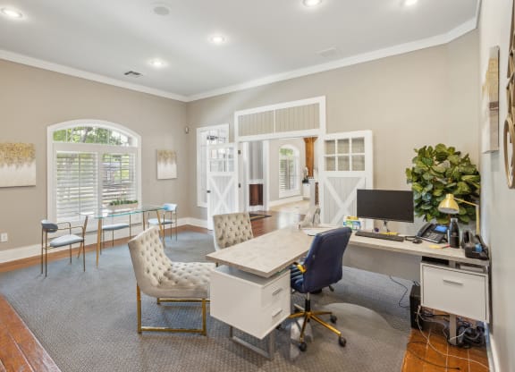 a home office with a white desk and chairs