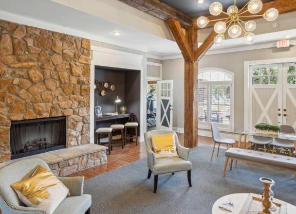 a living room with a fireplace and a table with chairs