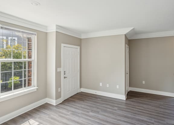 an empty room with a door and a window