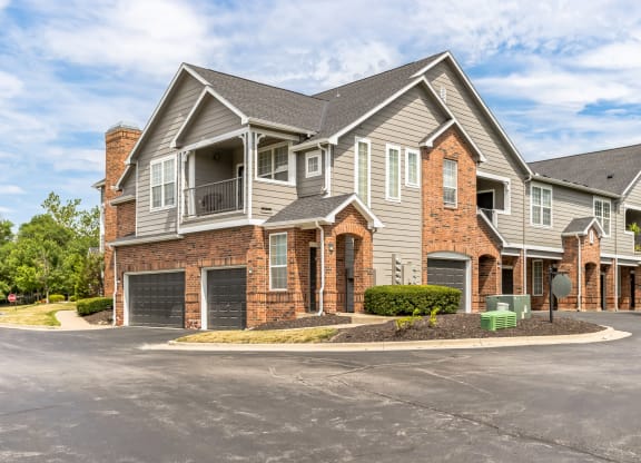 a large house with a driveway and a street in front of it