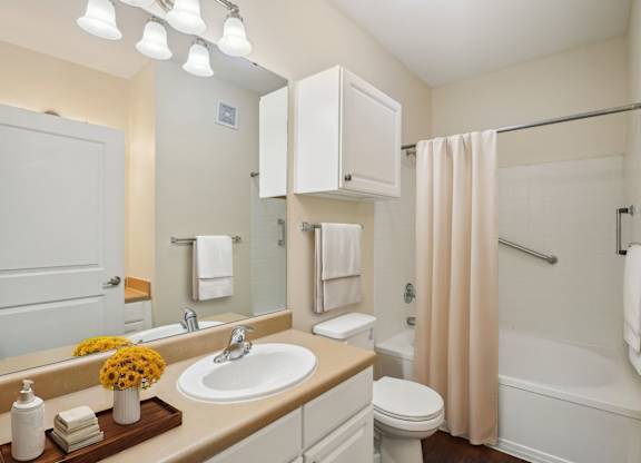 A bathroom with a sink, toilet, and bathtub.