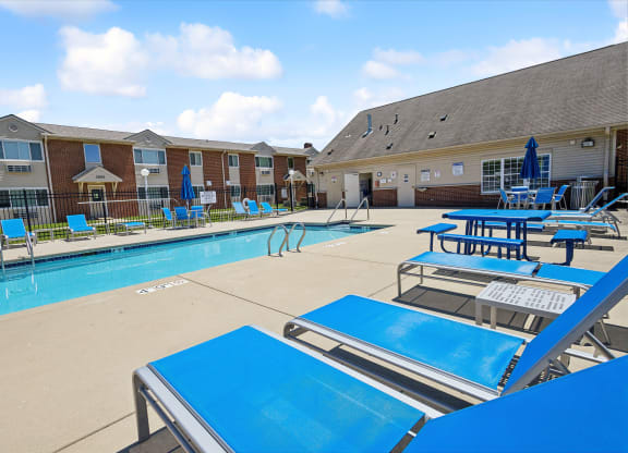our apartments have a large pool with tables and chairs
