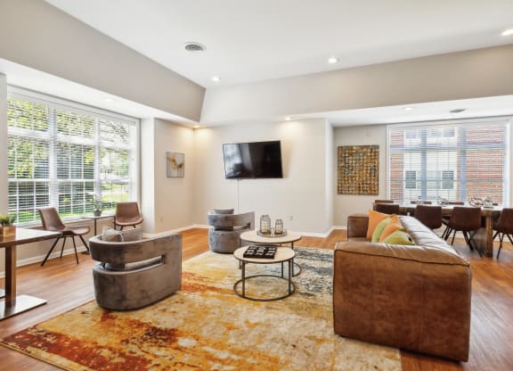 a living room with a couch and chairs and a tv
