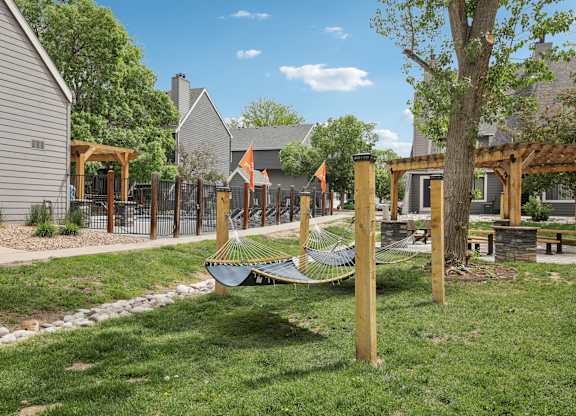 A playground with a hammock and a slide.